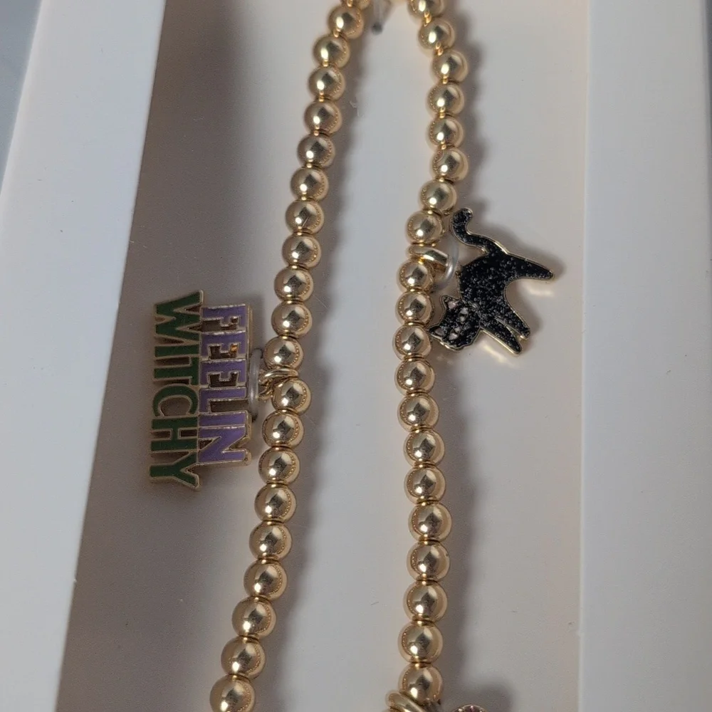 BaubleBar Halloween Themed Gold Tone Phone Charm Wristlet